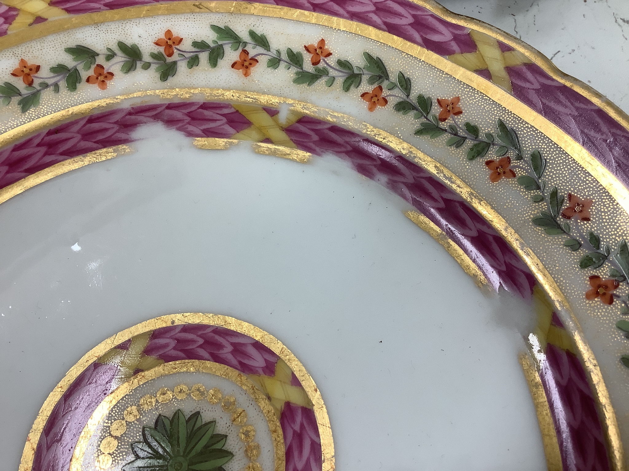 A Sevres circular dish finely painted with flowers and intricately gilded, blue mark, 1850's and a Rue Thiroux or Fabrique de la reine porcelain plate with Queen Marie Antoinette' mark of Crown over A stencilled in red,